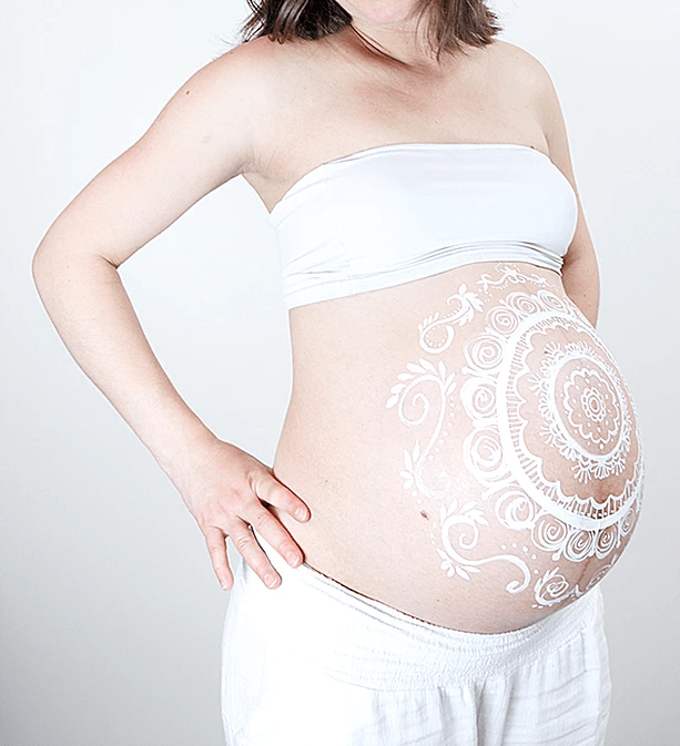 buste femme enceinte, ventre recouvert de peinture blanche réalisée avec la technique du belly painting